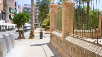 Blurry outdoor street scene with a defocused city background including palm trees, buildings, and sunny weather, ideal for urban and travel themes featuring blurred elements