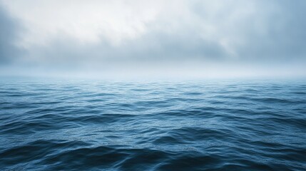 Fototapeta premium Expansive ocean and overcast sky backdrop tranquil water on a misty day embodying the essence of travel or vacation themes