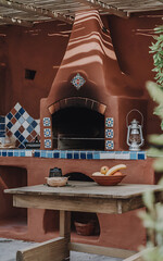 Rustic outdoor kitchen with red brick and blue tile  perfect for summer grilling and entertaining   