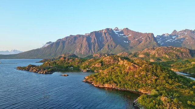 Aerial view of the dramatic coastline with majestic mountains under the midnight sun, Hanoy, Lofoten, Norway.