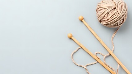 Knitting Needles with Yarn on Grey Background