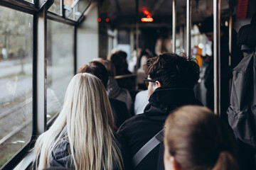 People commuting to work on a tram in the morning.