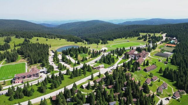 Aerial view of serene mountain landscape with village and forest, Rogla, Slovenia.
