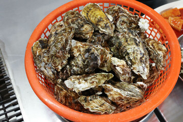 Korean seafood food. Fresh oysters in a basket