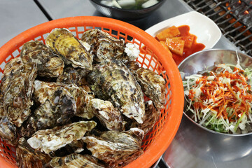 Korean seafood food. Fresh oysters in a basket