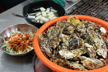 Korean seafood food. Fresh oysters in a basket
