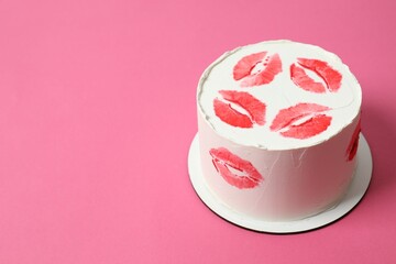 Colorful cake decorated with red lips on color background