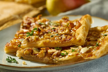 Two pieces of pear and blue cheese galette on plate