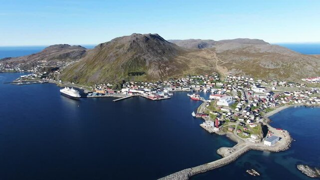 Aerial view of a picturesque village by the ocean surrounded by mountains, Honningsvag, Norway.