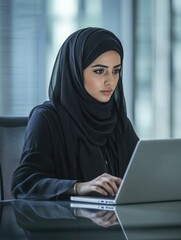 Woman using laptop with hijab