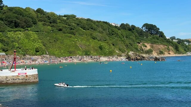 Aerial scene of the beach in East Looe with sea and green cliffs in Looe, UK