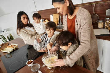 A joyful family blends ingredients while children eagerly participate in holiday baking in their kitchen.