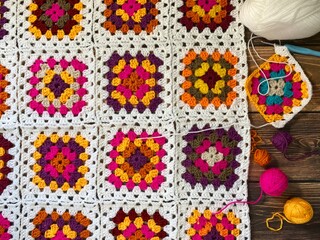 Granny square crocheted blanket with different colors motives, retro vintage craft handmade...