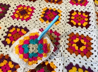 Granny square crocheted blanket with different colors motives, retro vintage craft handmade...