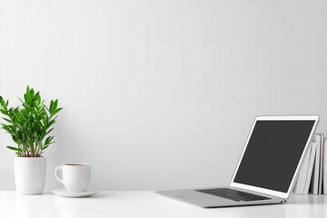 Fototapeta premium A clean, minimalist white desk setup featuring an open laptop, a small green potted plant, and a coffee cup, arranged against a plain background, creating a serene workspace ideal for productivity