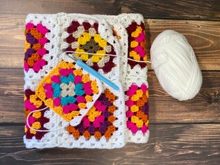 Granny square crocheted blanket with different colors motives, retro vintage craft handmade...