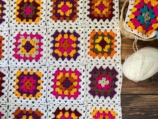 Granny square crocheted blanket with different colors motives, retro vintage craft handmade...