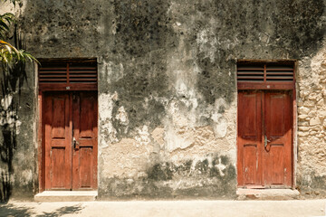 A Swahili door or Zanzibar door on the entrance of the Old Fort - An abandoned historical building in Old Stone Town, Bagamoyo, Tanzania
