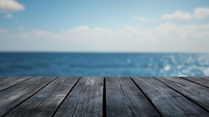 Dark wooden tabletop with a softly blurred seascape and clear blue sky in the background High resolution image