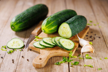 sliced cucumbers on wooden board