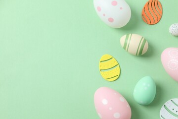 Happy Easter card. Easter eggs and decoration on color background, top view