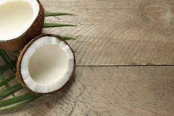 Coconut with leaves on wooden background