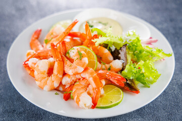 plate of fresh shrimps with lemon and dipping sauce