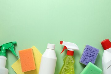 Many different house cleaning products on color background, top view