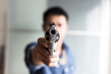 Mafia rich man in jean shirt with gold holding gun