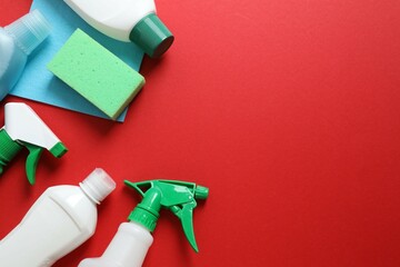 Many different house cleaning products on color background, top view