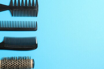 Professional combs and hairdresser tools on color background, top view