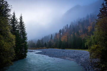 creek in mountains of karwendel in autumn at sunrise with fog