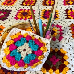 Granny square crocheted blanket with different colors motives, retro vintage craft handmade handiwork crocheting, beautiful plied photo cozy winter or autumn background wool thing yarn lovely warm 
