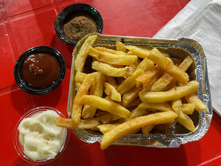 French Fries with ketchup and mayo sauces