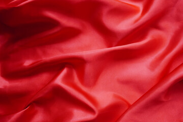 Texture red satin or silk is beautiful and luxurious (blurred).