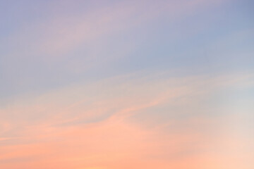 A beautiful sky tinted by the sun leaving vibrant shades of gold, pink, blue and multicolored. Clouds in the twilight evening and morning sky. Cloudy sky background in the evening, and during the day.