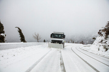 Snow plow removing snow from street.