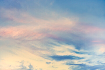 Obraz premium A beautiful sky tinted by the sun leaving vibrant shades of gold, pink, blue and multicolored. Clouds in the twilight evening and morning sky. Cloudy sky background in the evening, and during the day.