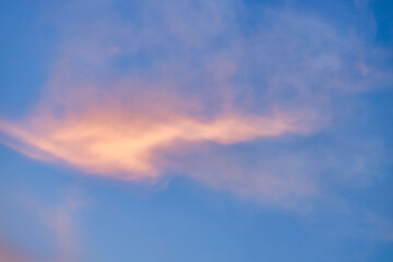 A beautiful sky tinted by the sun leaving vibrant shades of gold, pink, blue and multicolored. Clouds in the twilight evening and morning sky. Cloudy sky background in the evening, and during the day.