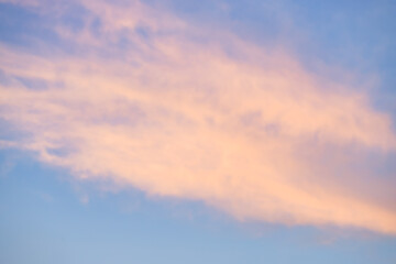 A beautiful sky tinted by the sun leaving vibrant shades of gold, pink, blue and multicolored. Clouds in the twilight evening and morning sky. Cloudy sky background in the evening, and during the day.