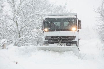 Snow plow removing snow from street.