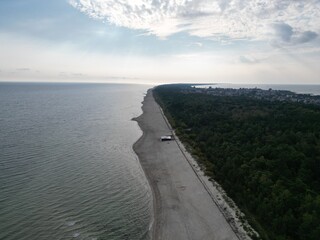 Aerial View of Coastline with Fog, Calm Sea, and Green Vegetation Creating Natural Textures