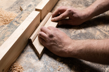 A carpenter is milling a part on a homemade machine