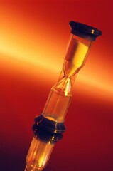 Hourglass Against Fiery Background Representing Time Passage