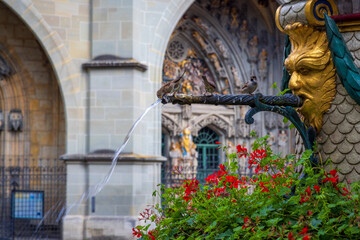 antic fountain in the place before cathedral of bern