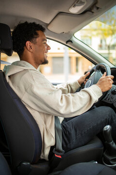Man driving car with both hands on steering wheel
