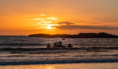 Sunset at Trearddur Bay with a lifeboat returning 