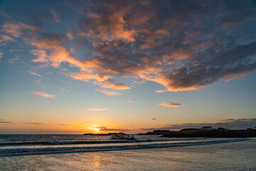 Sunset at Trearddur Bay with a lifeboat returning 