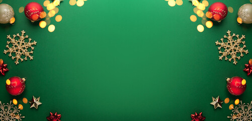 Merry Christmas and Happy Holidays greeting card, frame, banner. New Year. Noel. Red, golden Christmas ornaments on green background top view. Winter xmas holiday theme. Flat lay	
