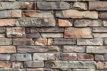 Obraz premium A high-resolution texture of weathered, multi-colored bricks is perfect for background use in design projects, adding a touch of history and rustic charm.